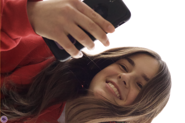 A student on her phone with an award-winning smile